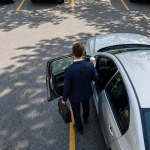 Driver getting into a car in a parking lot for a guide about car insurance deductibles