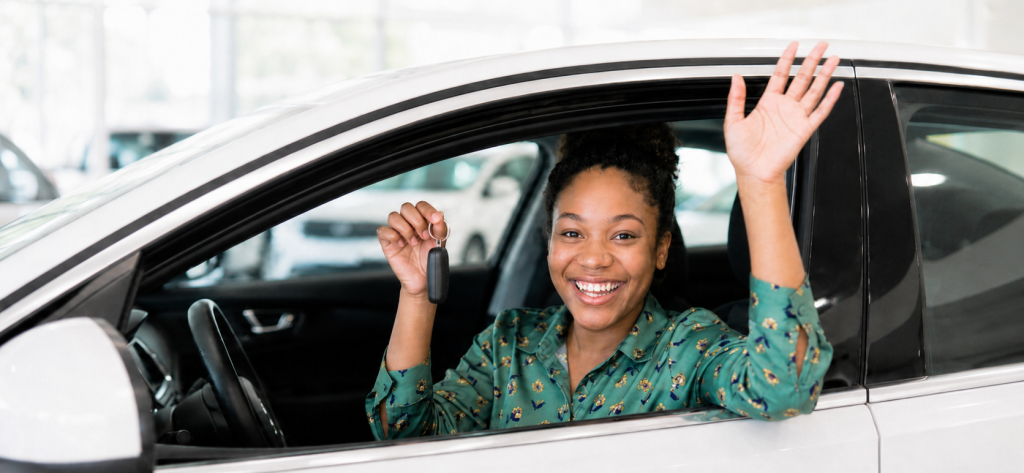 First-time driver holding car keys in a new car