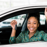 First-time driver holding car keys in a new car
