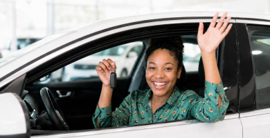 First-time driver holding car keys in a new car