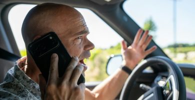 High-risk driver calling insurance company from his car