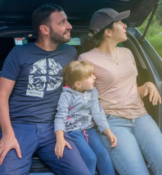 Family sitting in an SUV while reviewing full coverage car insurance protection