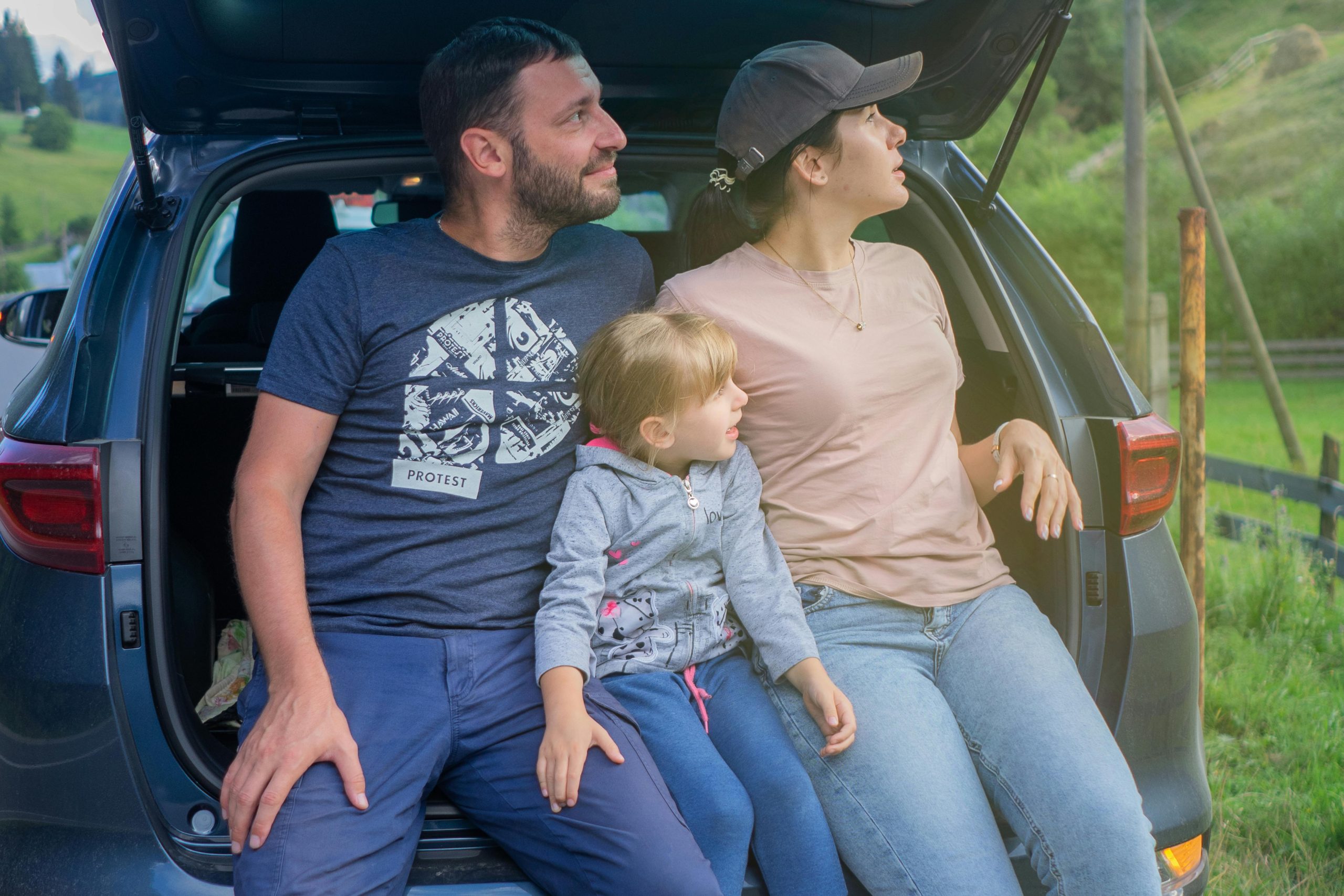Family sitting in an SUV while reviewing full coverage car insurance protection