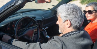 Senior driver sitting in a convertible car