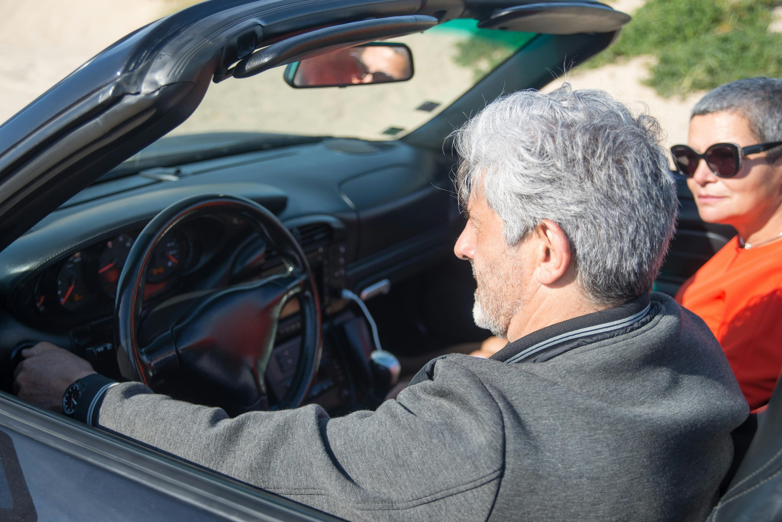 Senior driver sitting in a convertible car