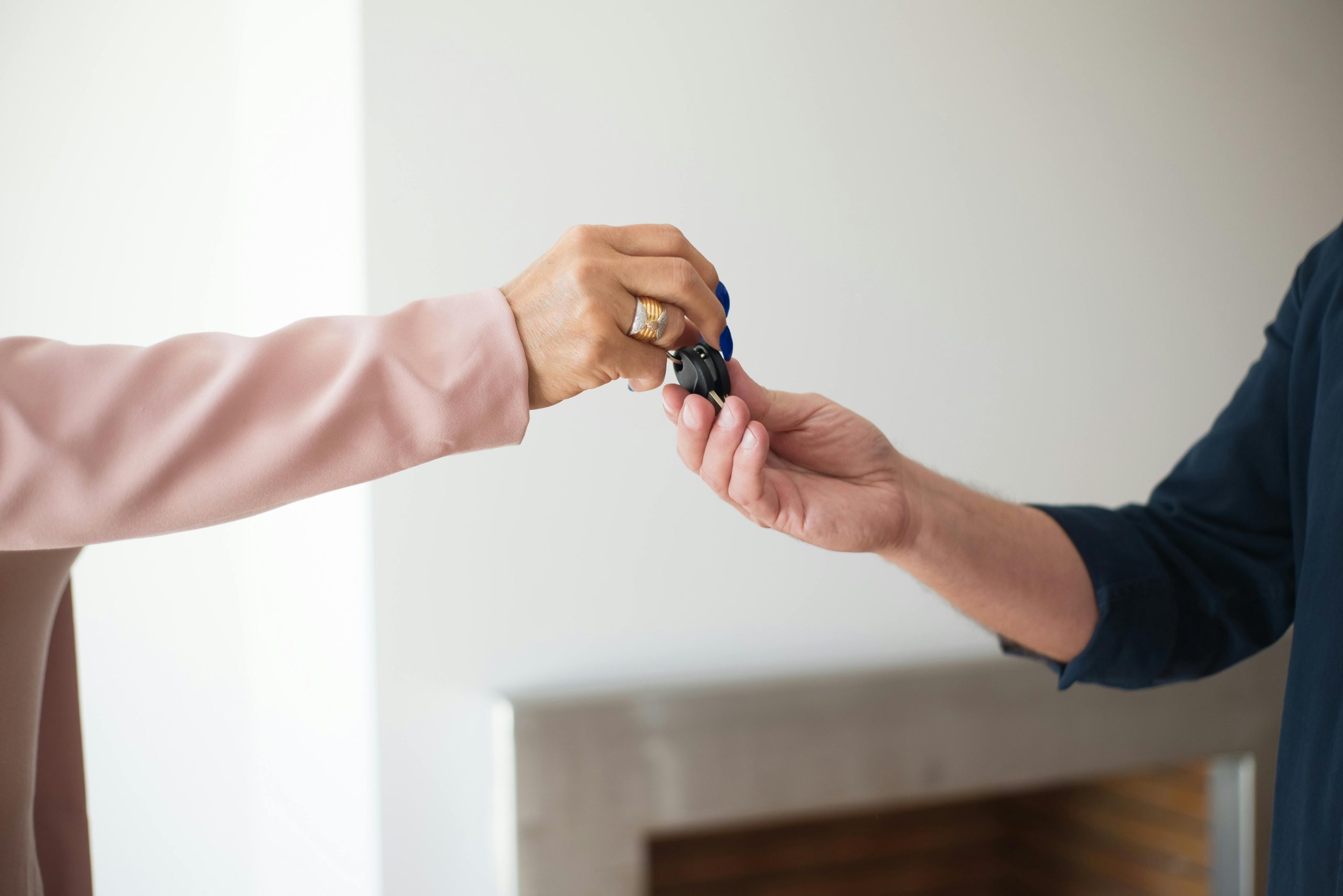 Car keys being handed over to someone borrowing another person’s car