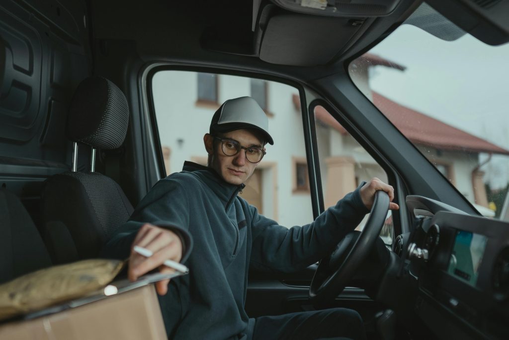 Delivery driver loading packages into a delivery van