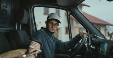 Delivery driver loading packages into a delivery van