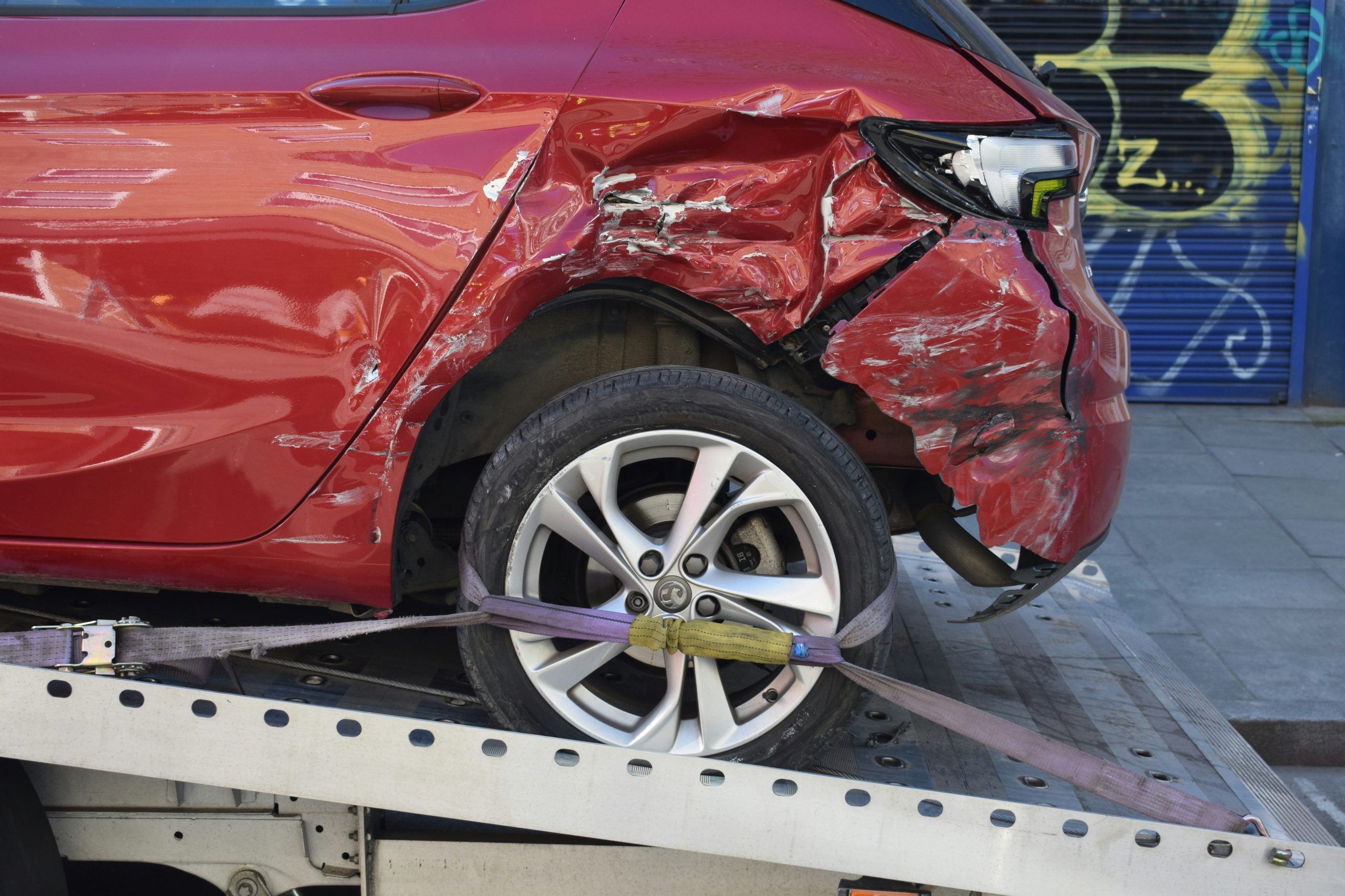 Damaged car being towed after an accident