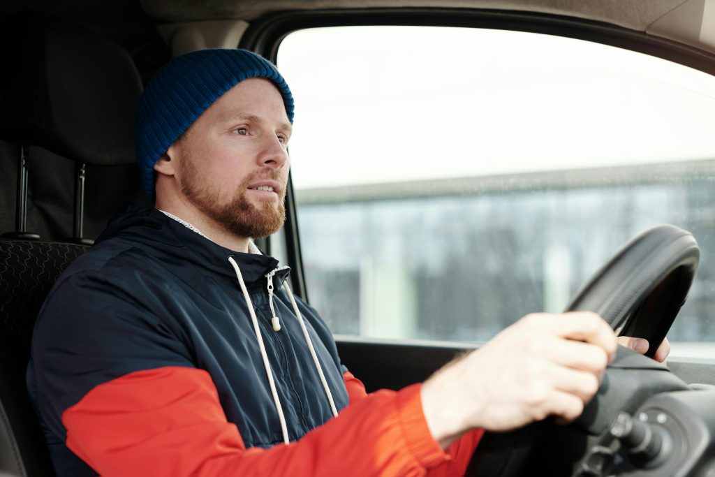 Driver behind the wheel for pay-per-mile car insurance