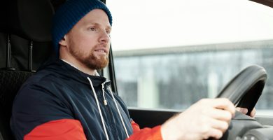 Driver behind the wheel for pay-per-mile car insurance