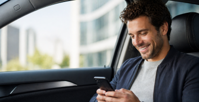 Driver reviewing usage-based car insurance data on a smartphone