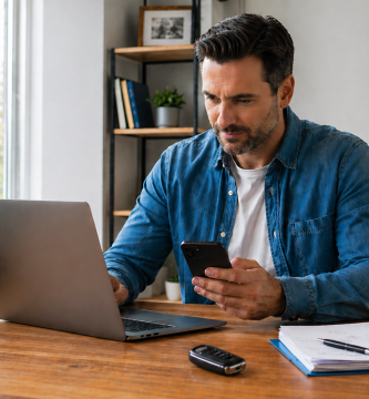 Driver comparing car insurance options before switching mid-policy