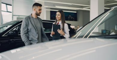 Driver discussing temporary car insurance options at a car dealership in Texas