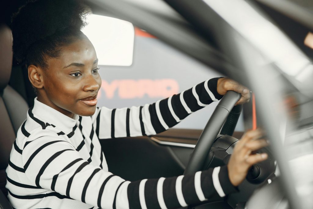 Young driver sitting behind the wheel of a car
