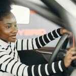 Young driver sitting behind the wheel of a car